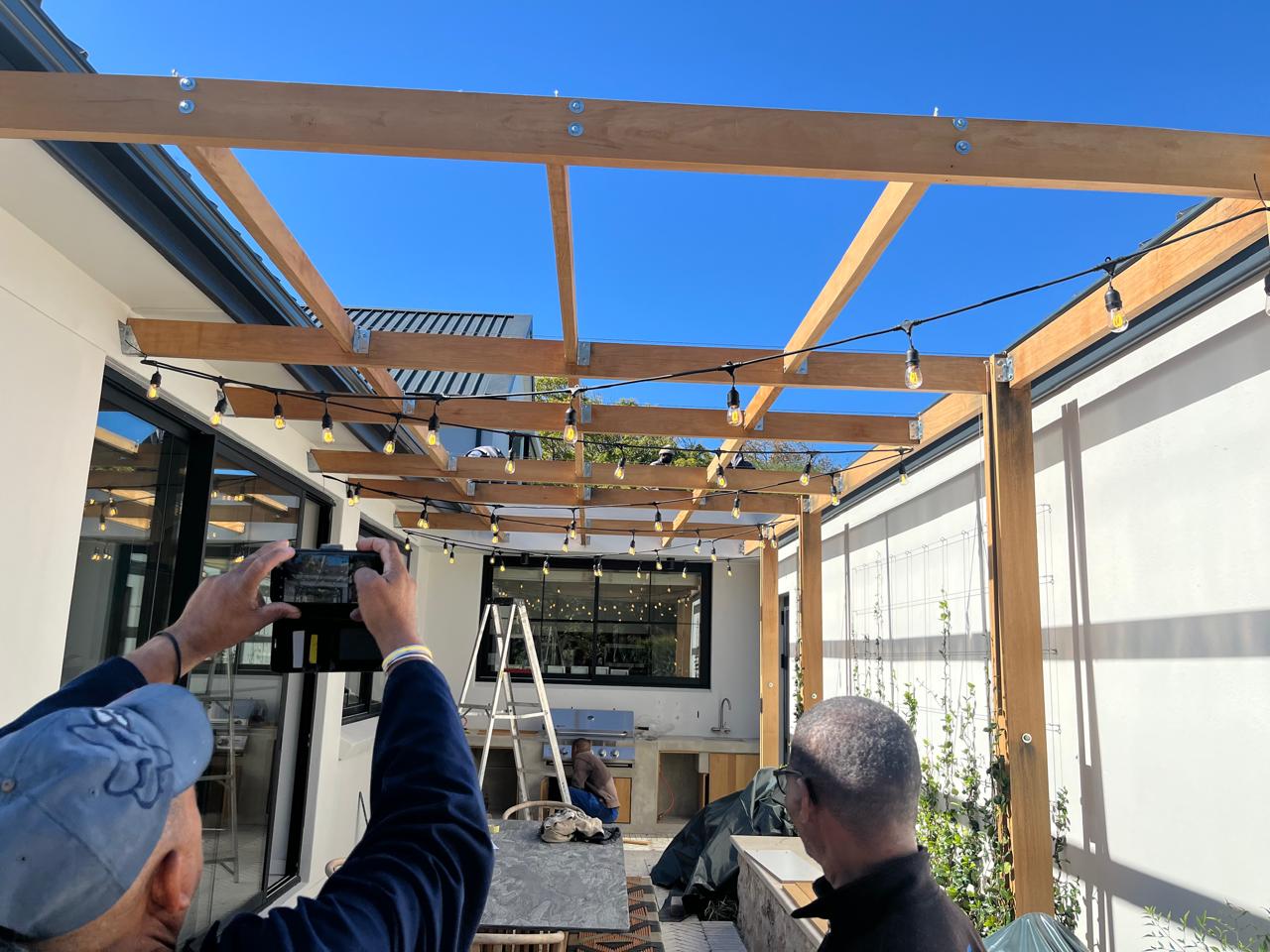 Timber pergola with festoon lights over a courtyard