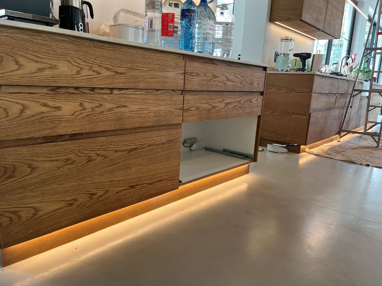 Custom oak cabinetry with LED toe lighting